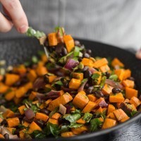 Tossing the black bean salad