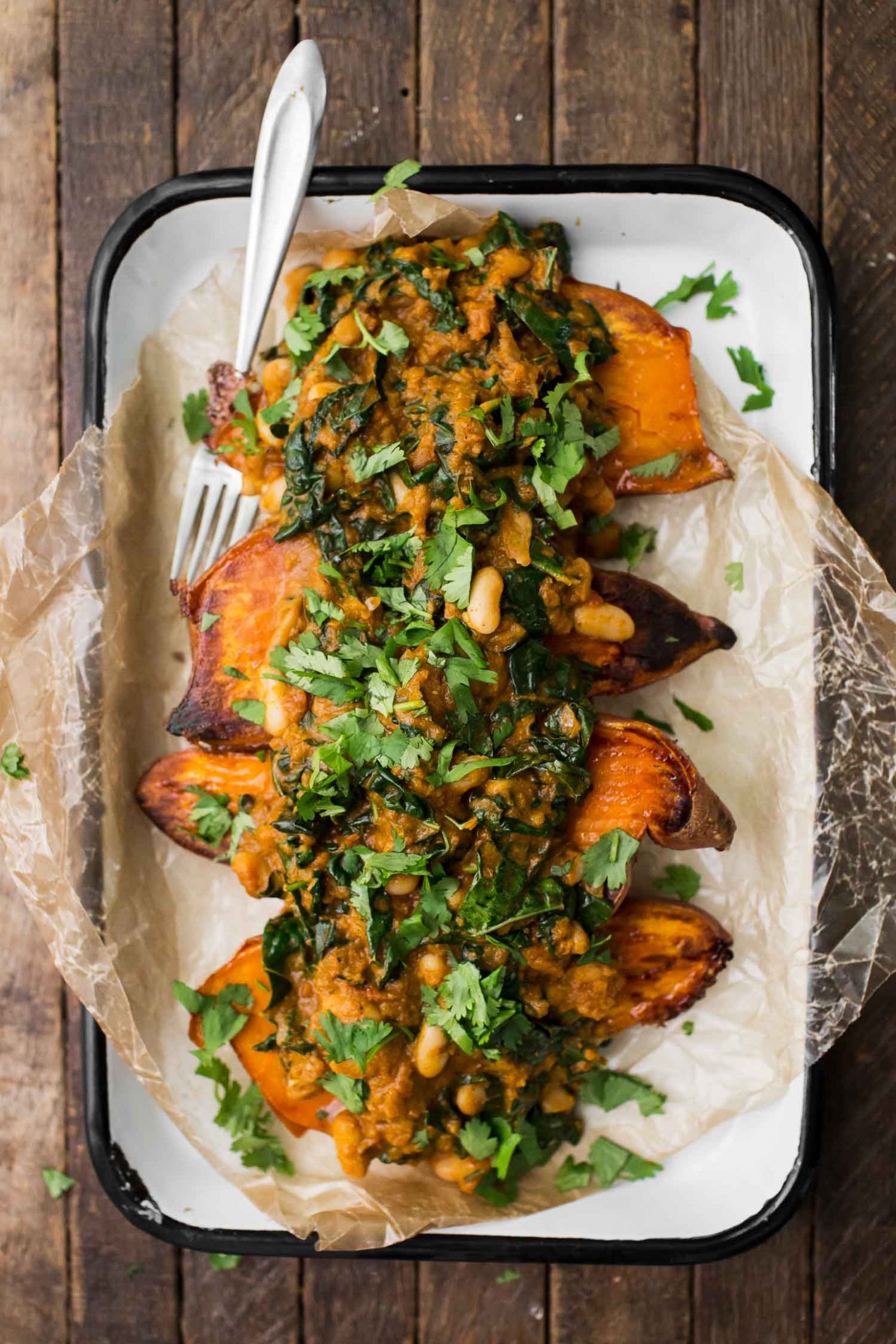 White Bean Masala Smothered Sweet Potatoes | http://naturallyella.com