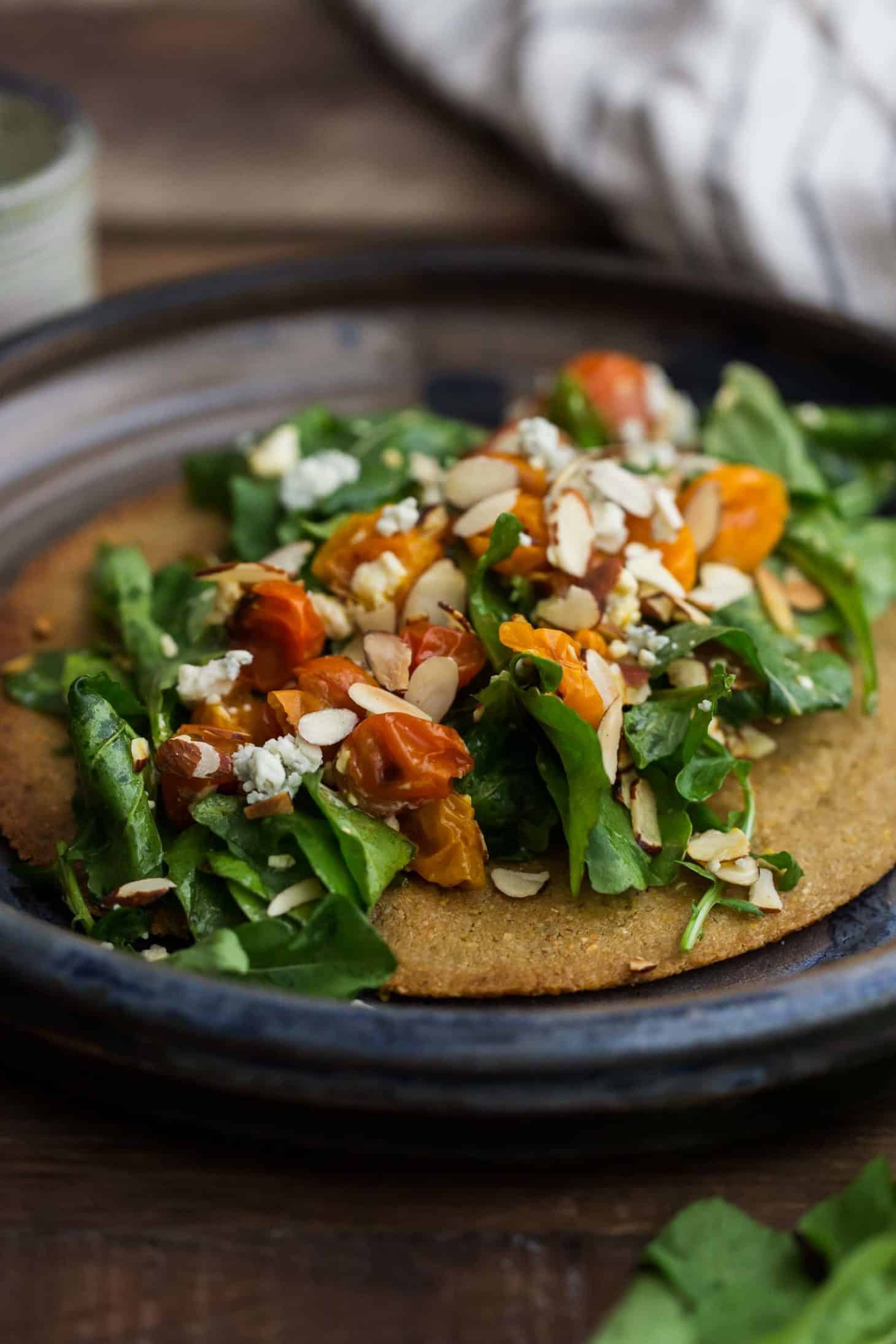 Oat Crisp with Burst Tomato Arugula Salad