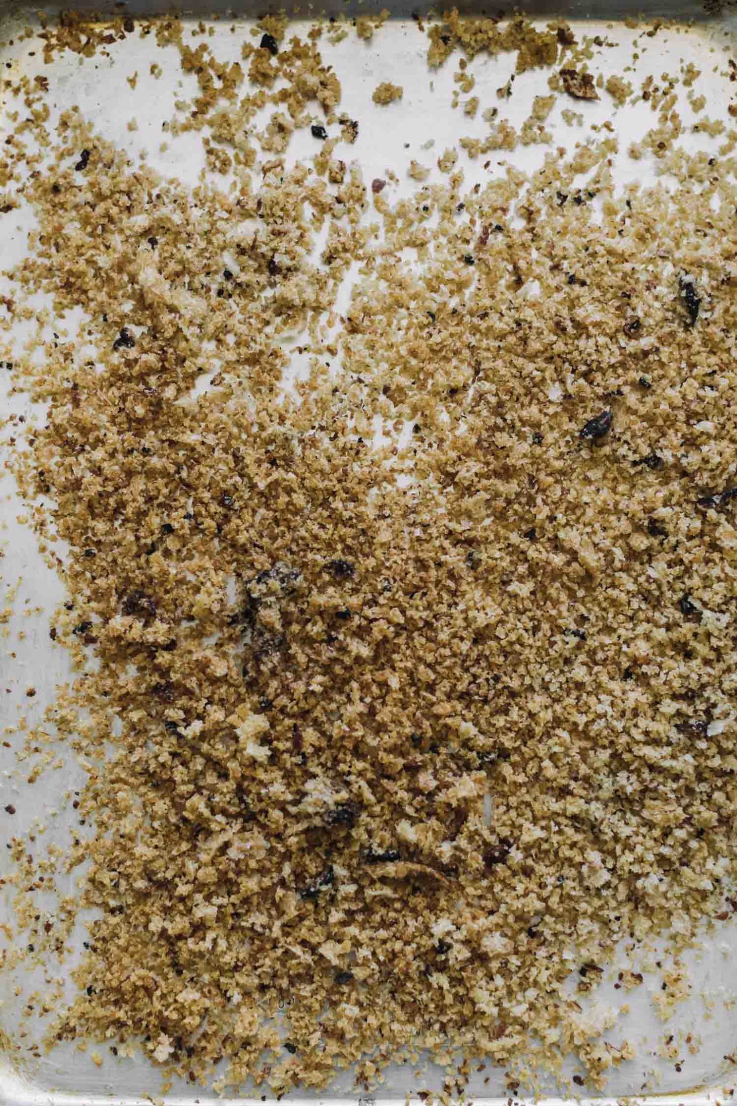 Overhead shot of homemade breadcrumbs on a sheet tray.