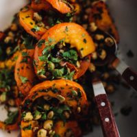 Close-up overhead photo of Chipotle roasted Red Kuri Squash with Chickpeas and herbs