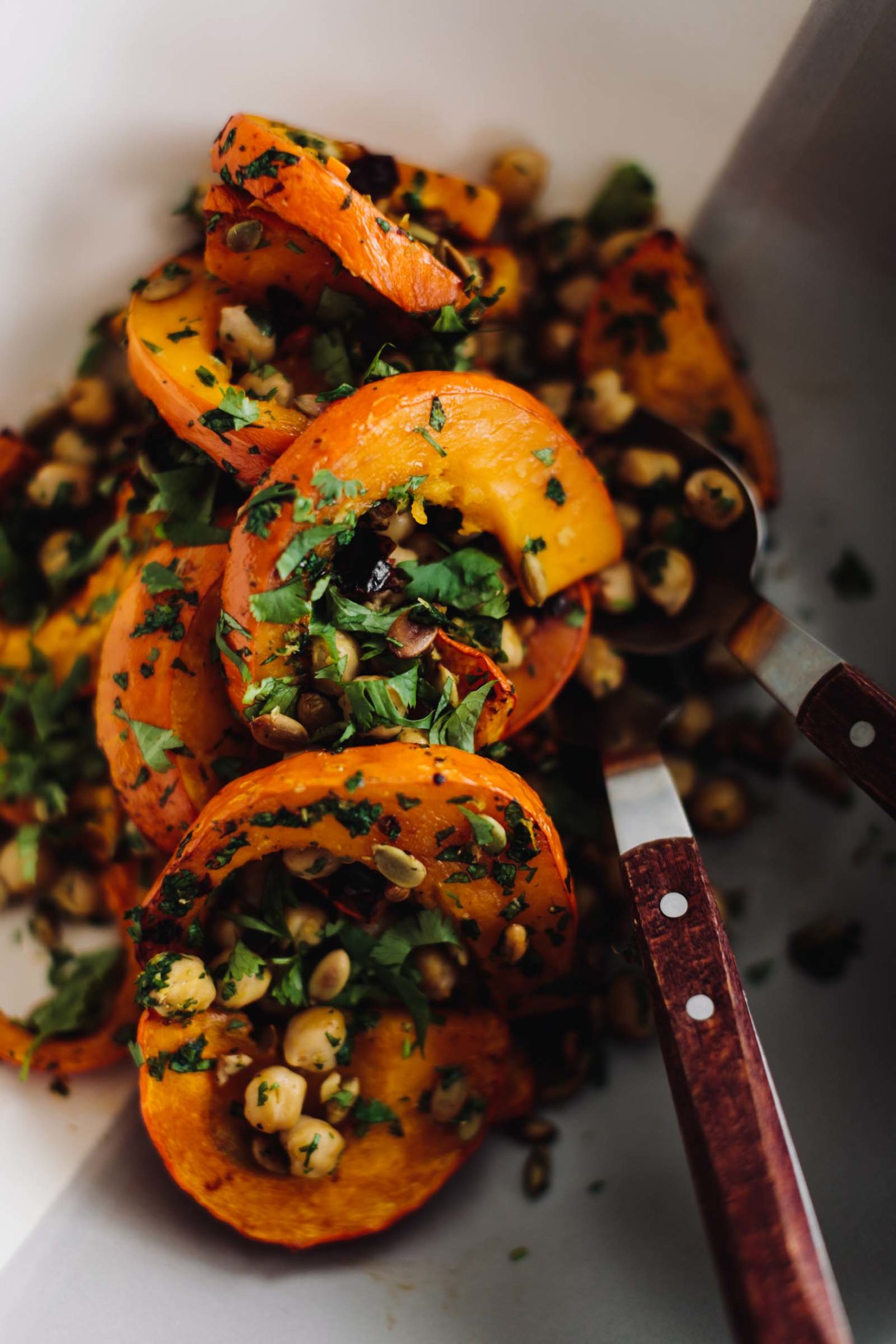 Close-up overhead photo of Chipotle roasted Red Kuri Squash with Chickpeas and herbs