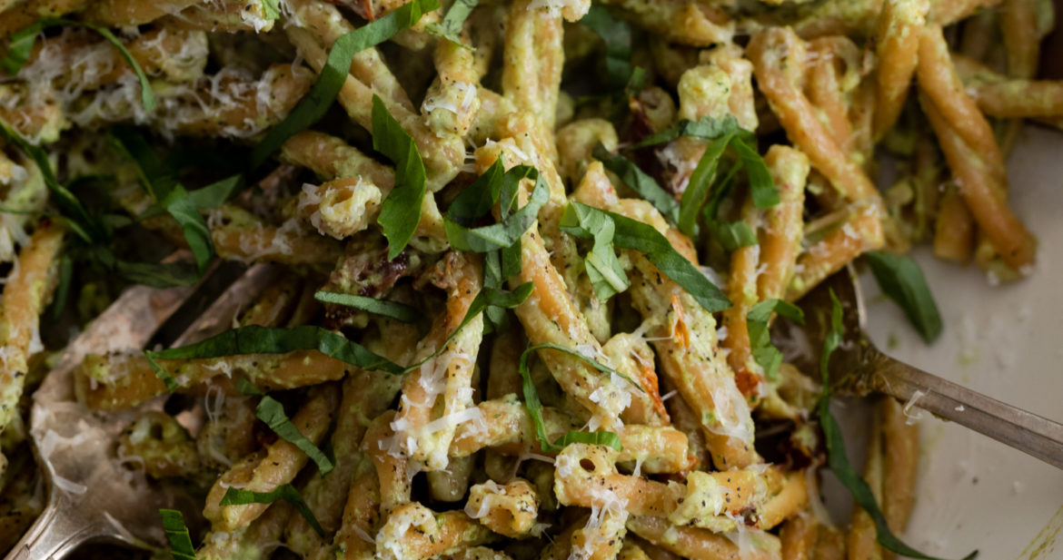 Close-up, overhead photo of a bowl of chickpea pasta tossed with a broccoli pesto.