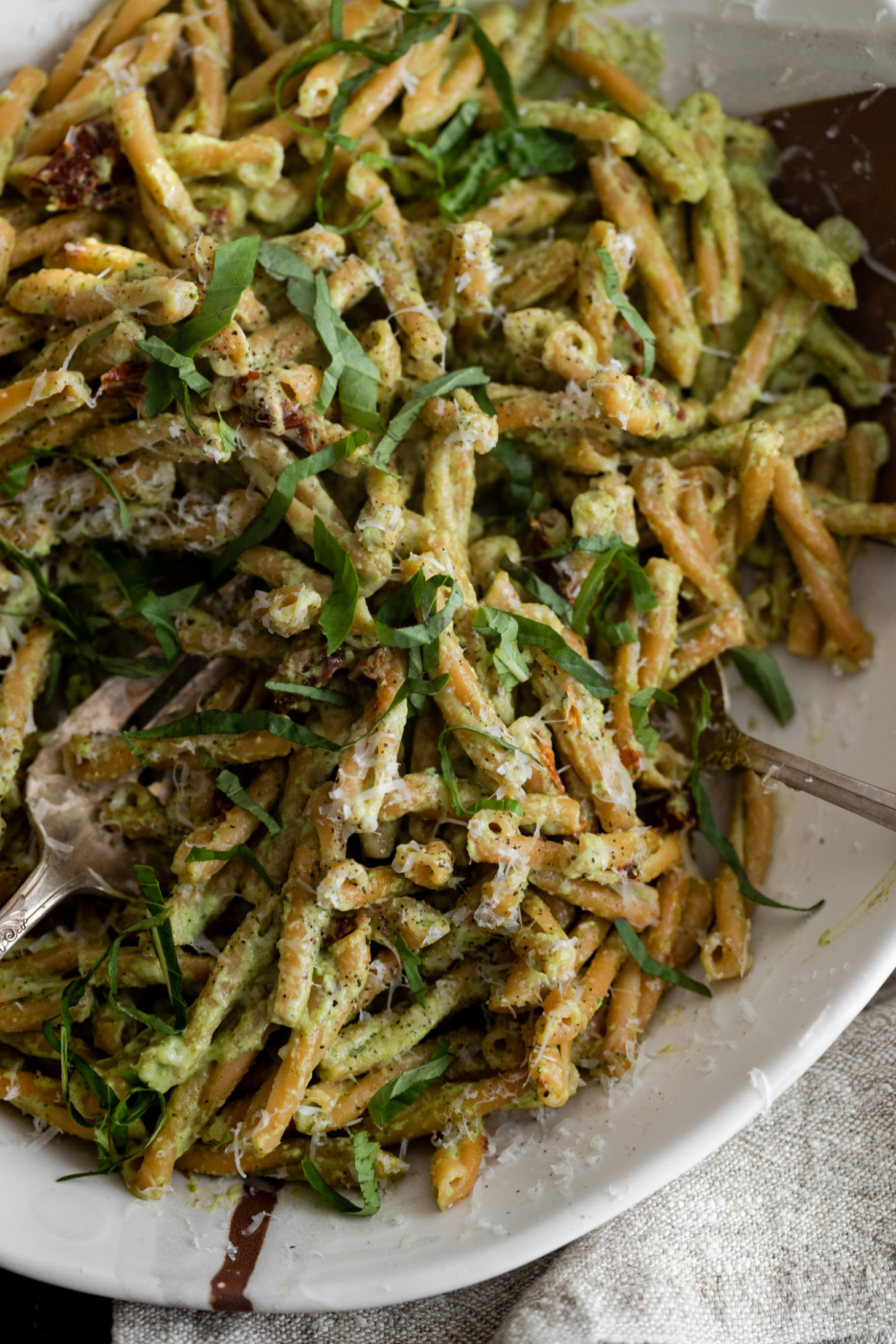 Close-up, overhead photo of a bowl of chickpea pasta tossed with a broccoli pesto.