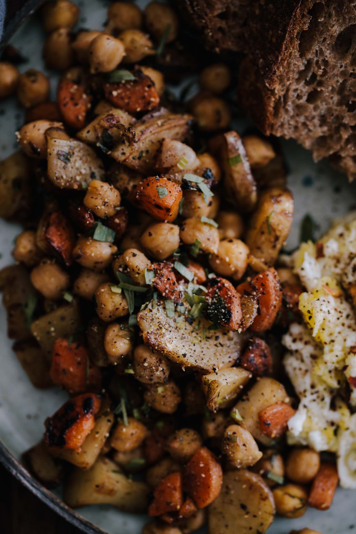 Close-up photograph of sunchoke hash with chickpeas and tarragon. 