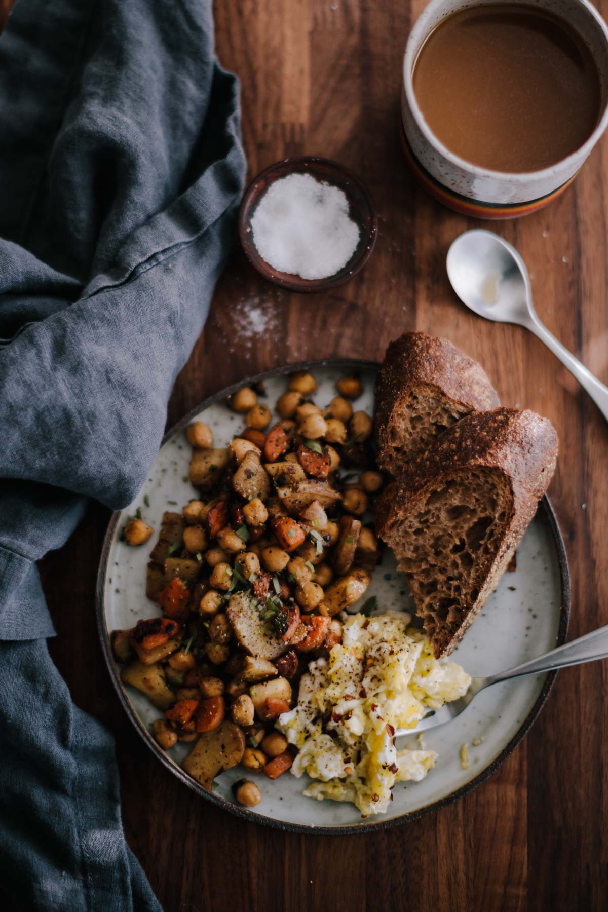Overhead photograph over sunchoke hash with chickpeas. Served with toast and scrambled eggs.