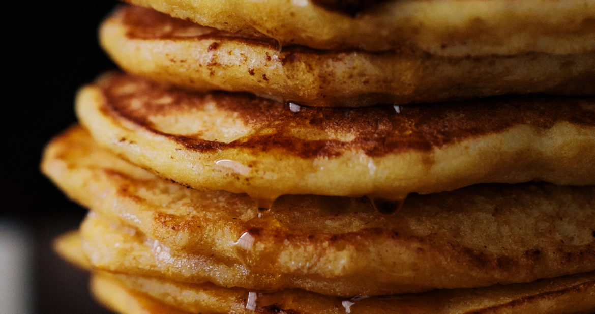 Close-up photograph of a stack of ricotta pancakes made with einkorn flour and kabocha squash puree.
