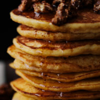 Close-up photograph of a stack of ricotta pancakes made with einkorn flour and kabocha squash puree.