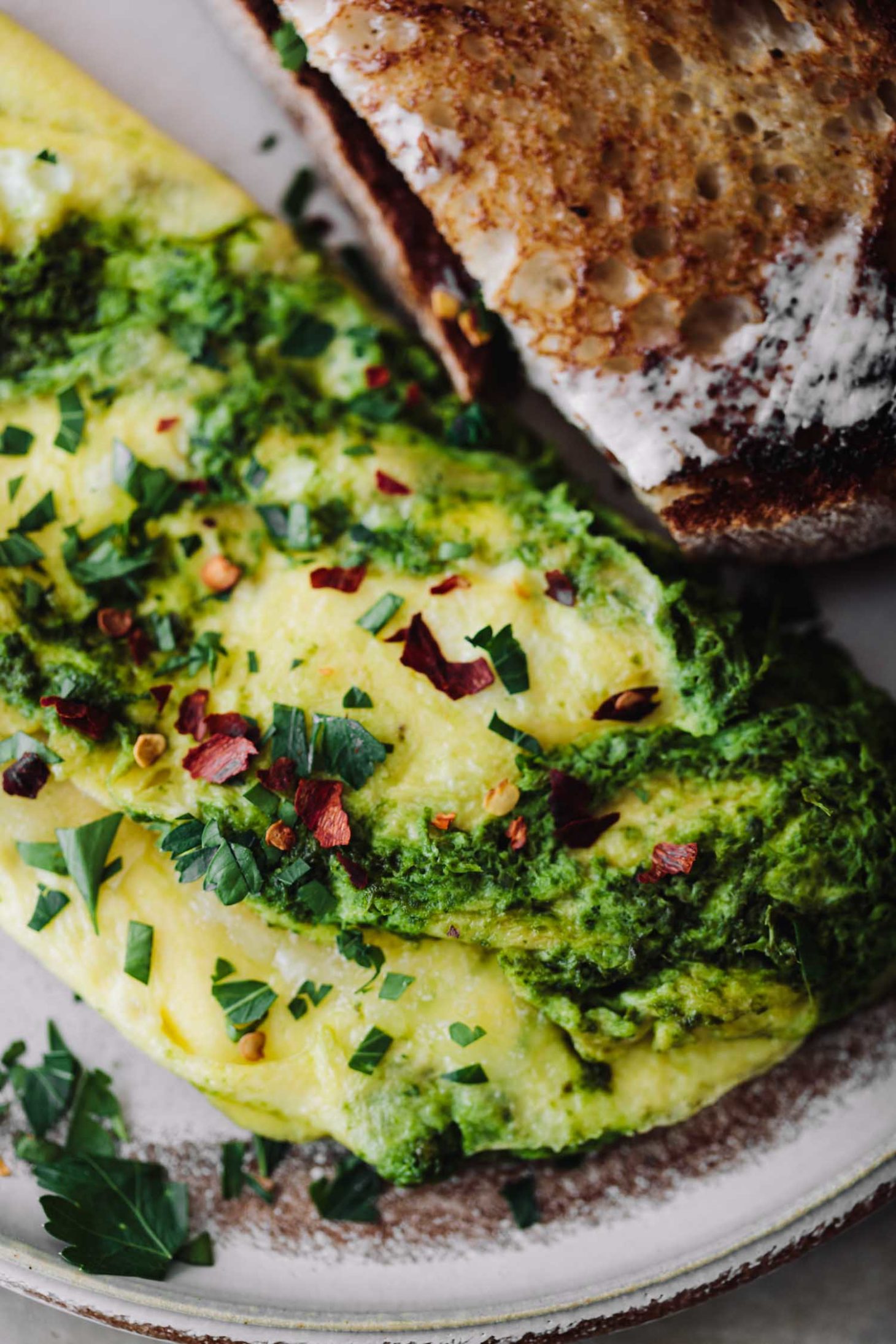 Close-up photograph of kale sauce omelette with manchego cheese.