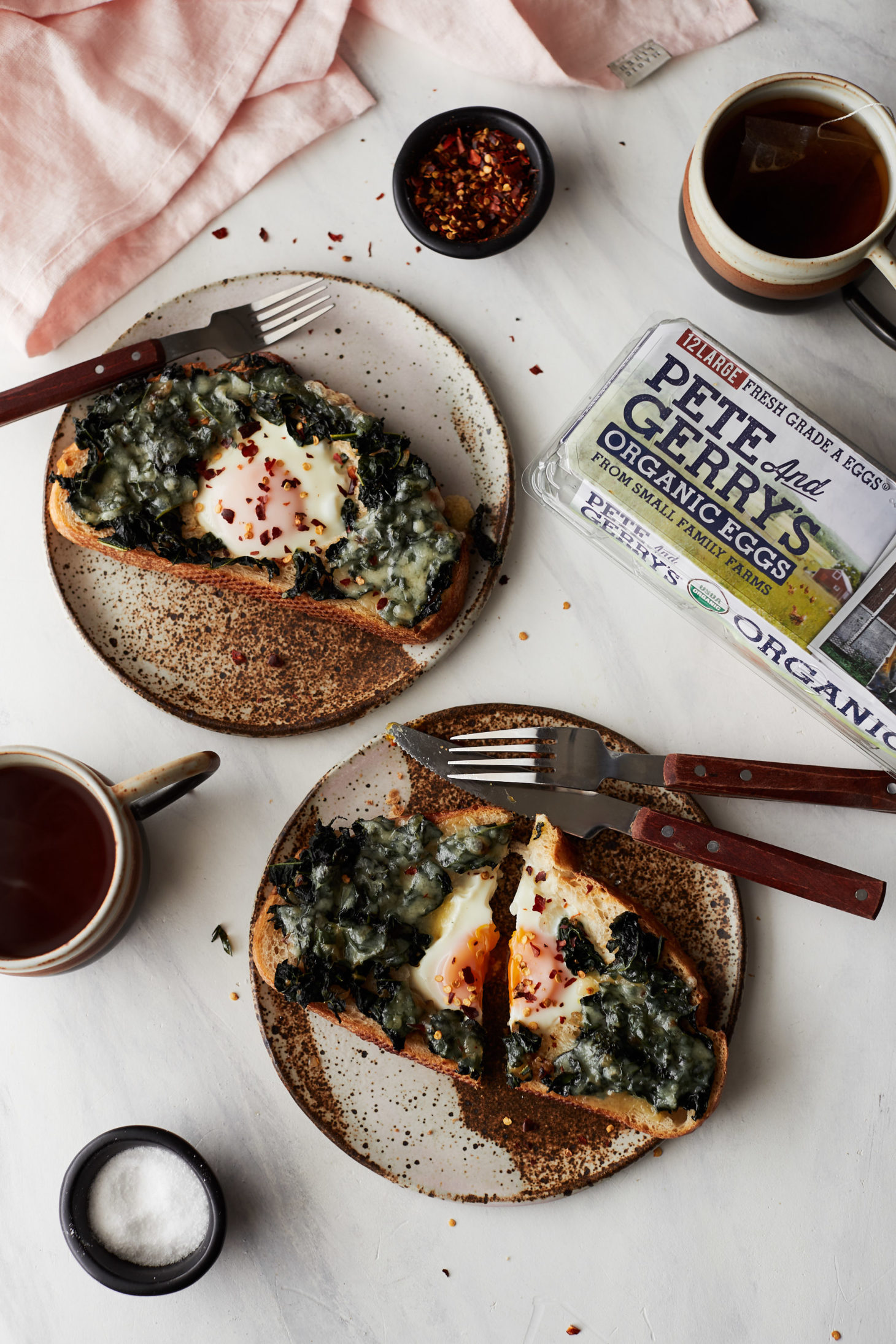 Overhead photograph of two egg in a hole with kale. 