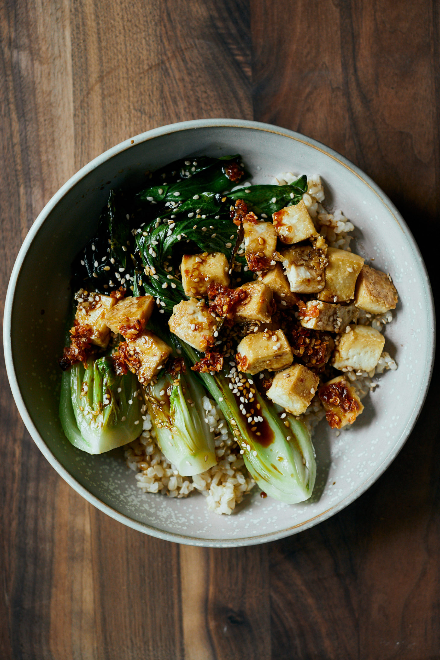 overhead photograph of a rice bowl with crispy tofu and seared bok choy