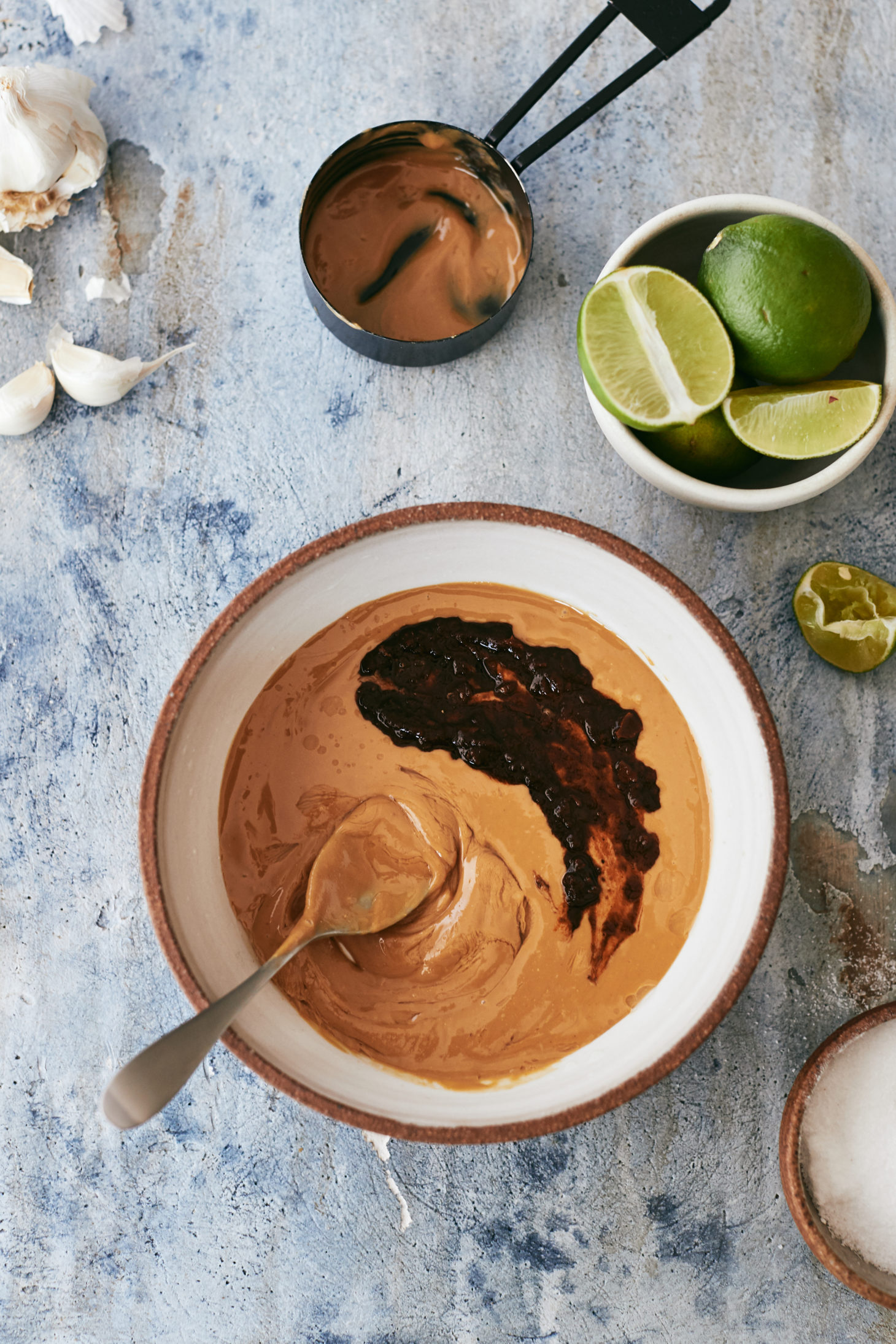 Overhead photograph of peanut sauce with chipotles and limes