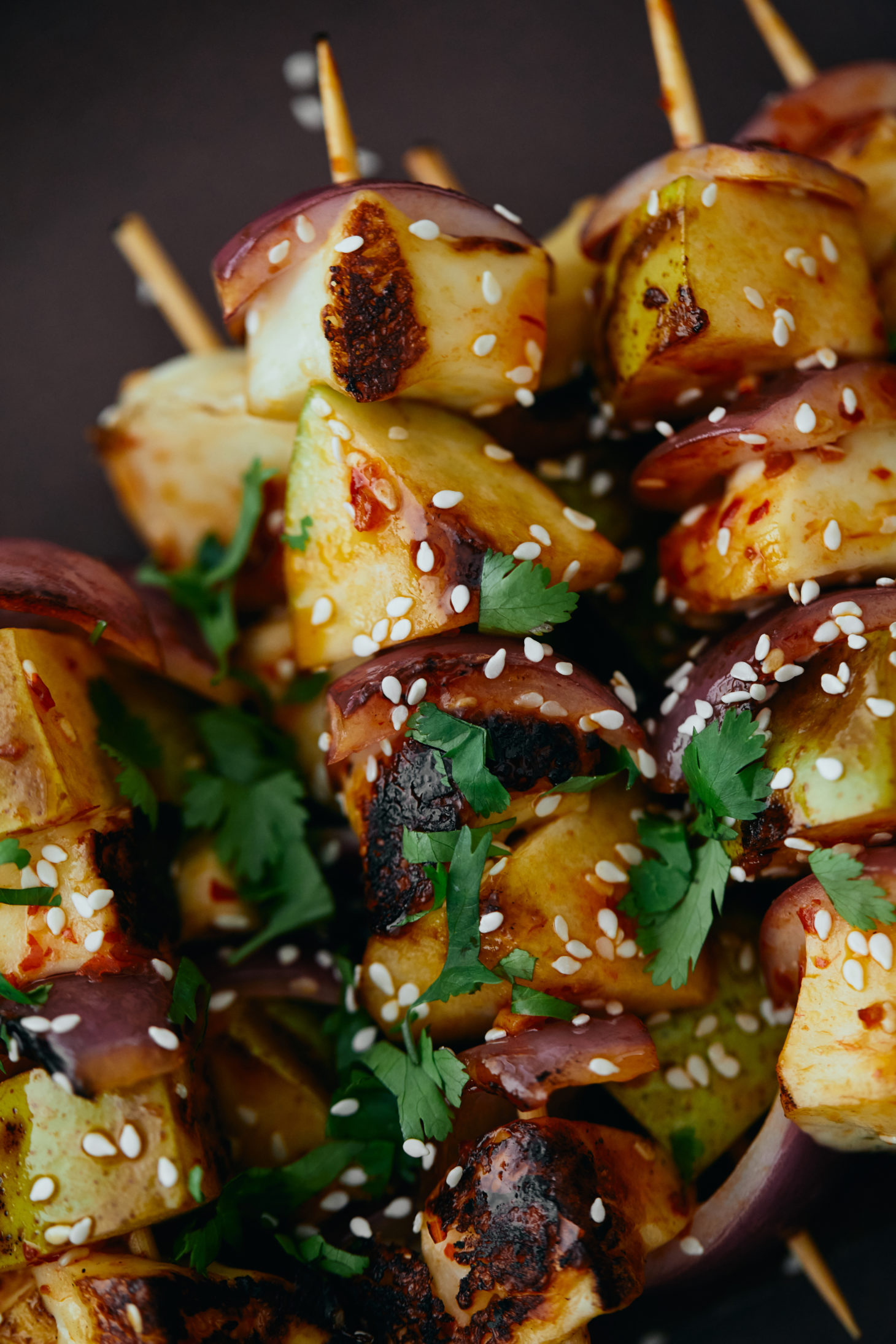 Close-up image of grilled pear skewers.