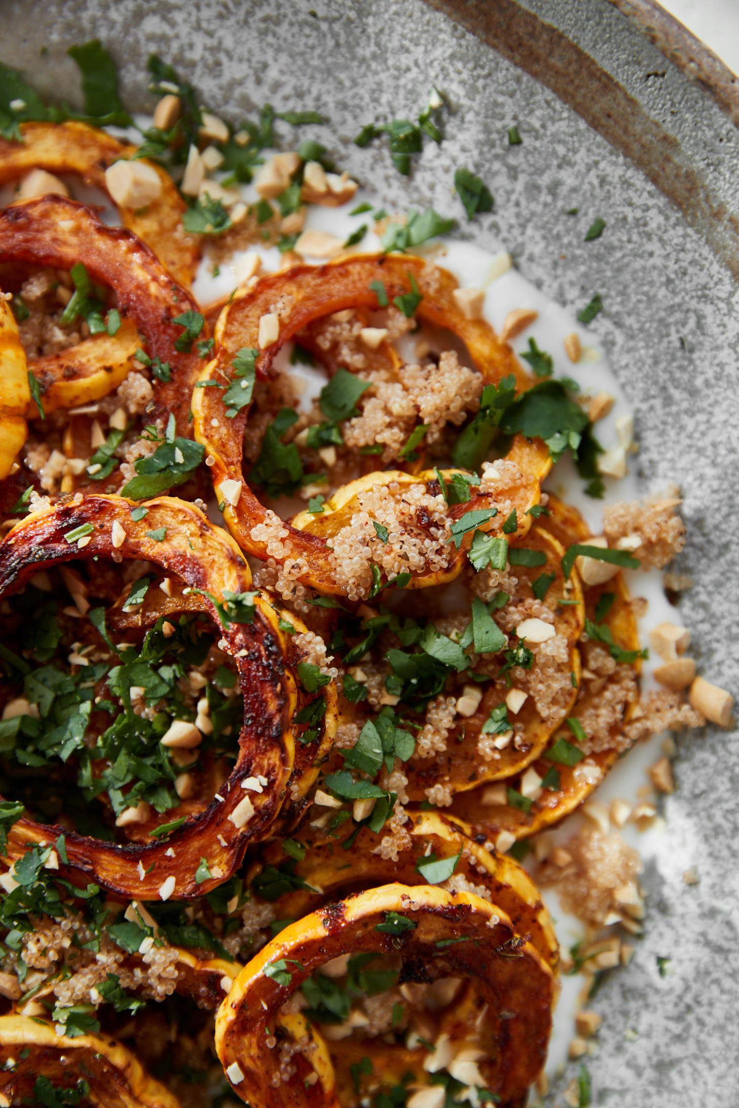 Close-up photo of roasted delicata squash tossed with cooked amaranth.