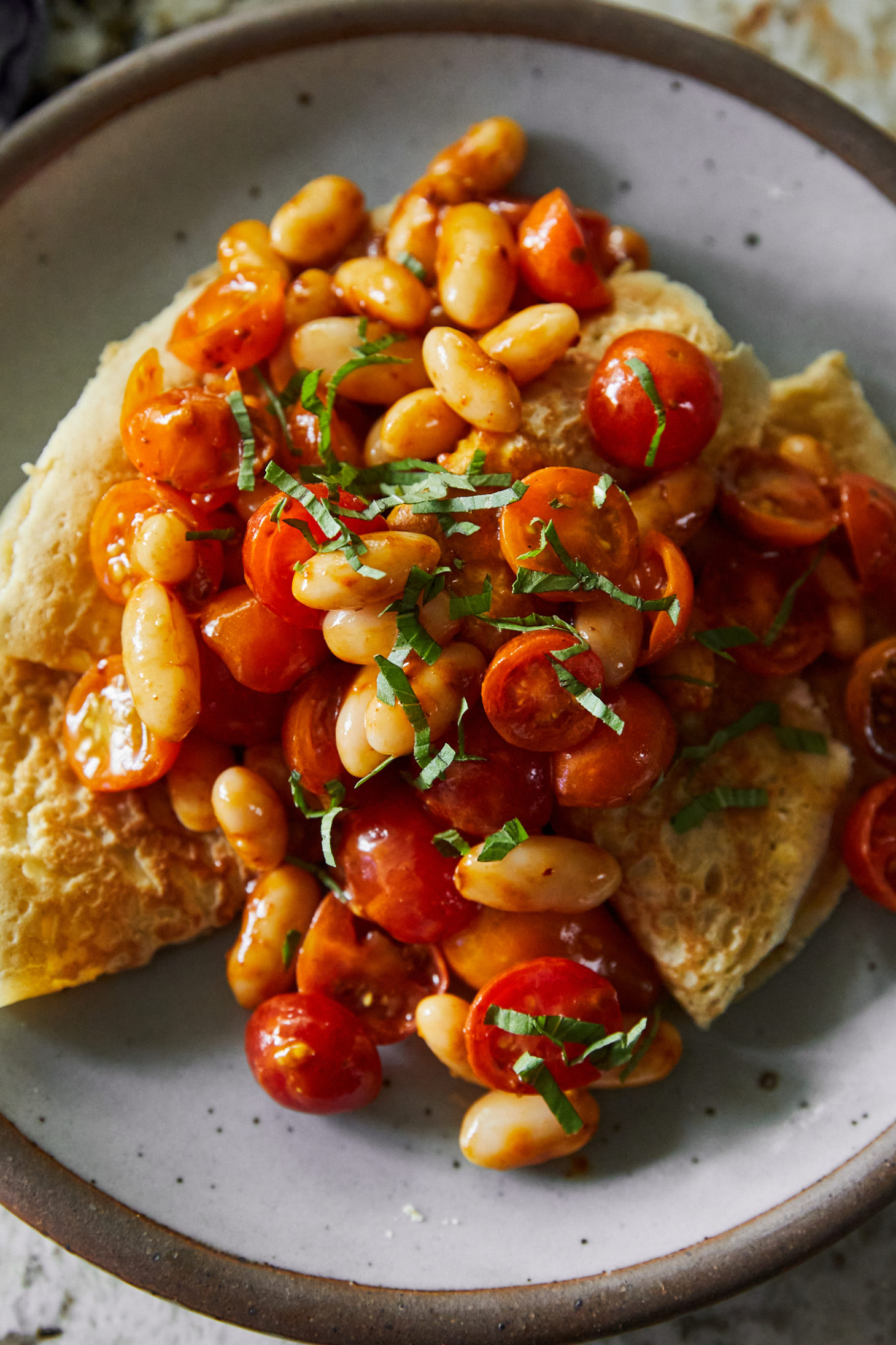 Oat Crepes with Harissa Beans and Tomatoes