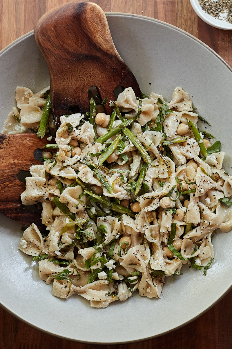 Wide photo of a asparagus pasta salad with chickpeas and farfalle pasta