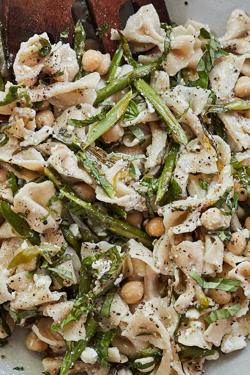 Close-up side photo of a asparagus pasta salad with chickpeas and farfalle pasta