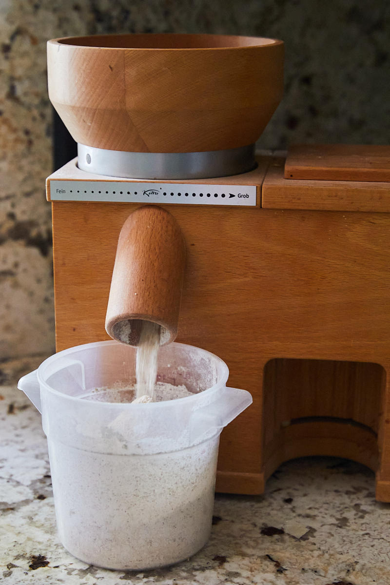 an image of grains being milled in a komo grain mill