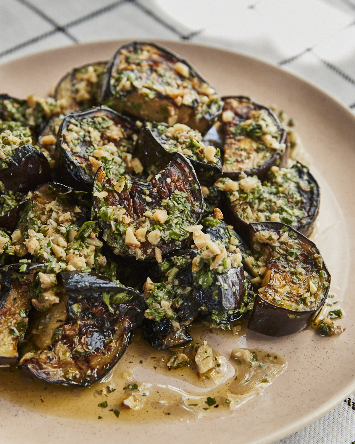 Close-up of grilled eggplant tossed in a walnut vinaigrette.